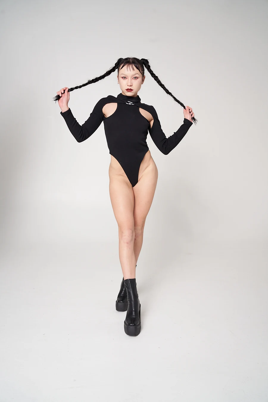 An LF black long-sleeved bodysuit with shoulder cut-outs, a high neckline and a small front fastening