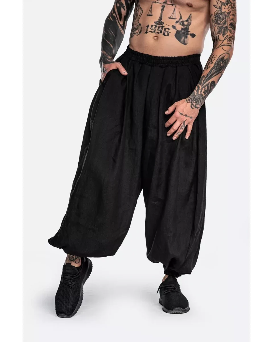 LF black Natural Samurai trousers with a wide cropped leg and a gathered waistband, shown with dark trainers